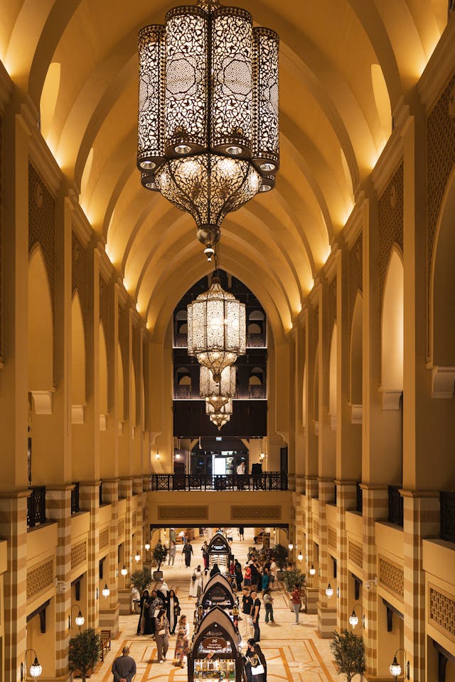 Collection of four insulated travel bottles on wooden shelf.